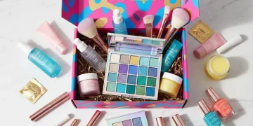Assortment of high-value beauty products from a subscription box, including skincare, makeup, and haircare items, artfully arranged.